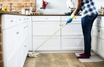 A lady cleaning the kitchen