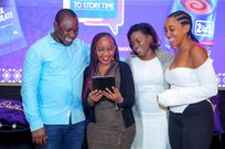 Naomi Wambui Author of Mimi The Bear holding a tablet reading her story to Richard Oduor- Publisher at Sisi Afrika and Lorna Kamemba - Senior Category Brand Manager Chocolates and Biscuits ROA (Rest of Africa) Cadbury Kenya, Mondelez International and Tatiana Karanja - digital content creator at Bao Box Nairobi.