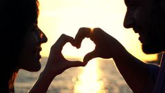 Couple making heart symbol with hands (Courtesy)