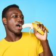 African man eating a banana