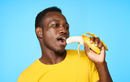 African man eating a banana