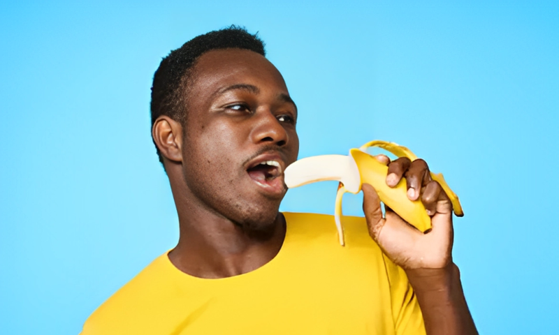 African man eating a banana