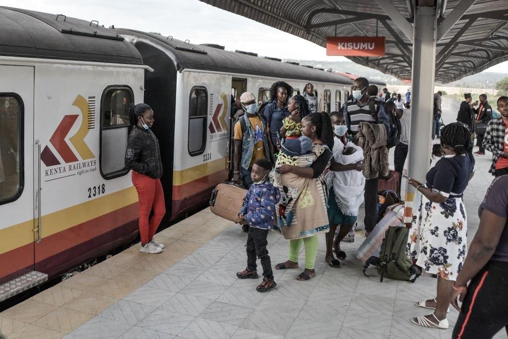 Passengers disembark from the train that arrived from Nairobi at the Kisumu railway station, on December 17, 2021. - Kenya railways resumed commuter services between Nairobi and Kisumu after it being non-operational for more than 10 years.  (Photo by BRIAN ONGORO/AFP via Getty Images)