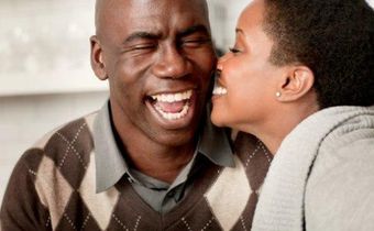 Young lady kissing older man