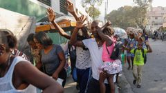 Residents flee their homes during clashes between police and gang members at the Portail neighborhood in Port-au-Prince, Haiti on February 29, 2024. Odelyn Joseph/AP