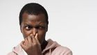 Black man holding his nose (image used for illustration) [iStock]