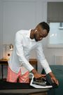 A man ironing clothes