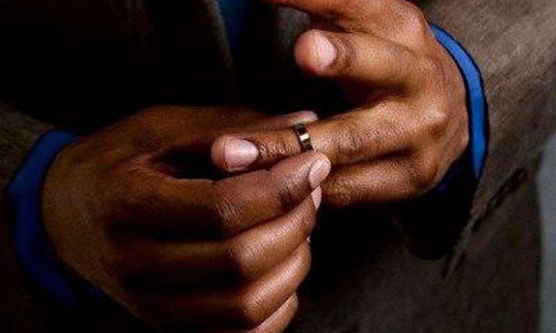 Man taking off wedding ring