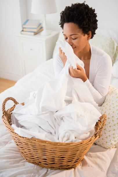 Woman folding white laundry