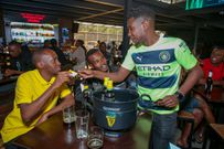 MC Lotan Salapei engages with football fan as they make their predictions in thepredict and win mechanic during the Guinness brightest matchday made by the fansat Bar Next Door, Kiambu Road