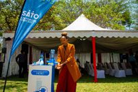 Ms Janet Mbugua, Founder of the Inua Dada Foundation and MC of the day demonstrates handwashing using a SATO tap, an innovation by Lixil