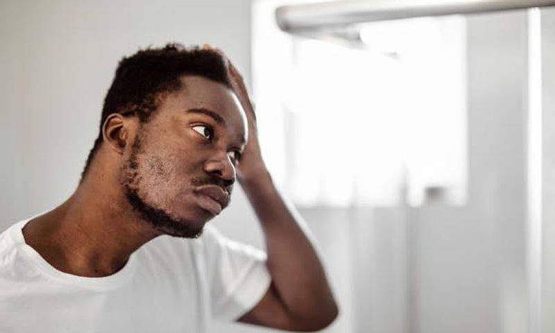 A man looking at himself in the mirror