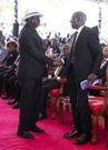 Former Prime Minister Raila Odinga and President William Ruto at Mukami Kimathi's funeral service