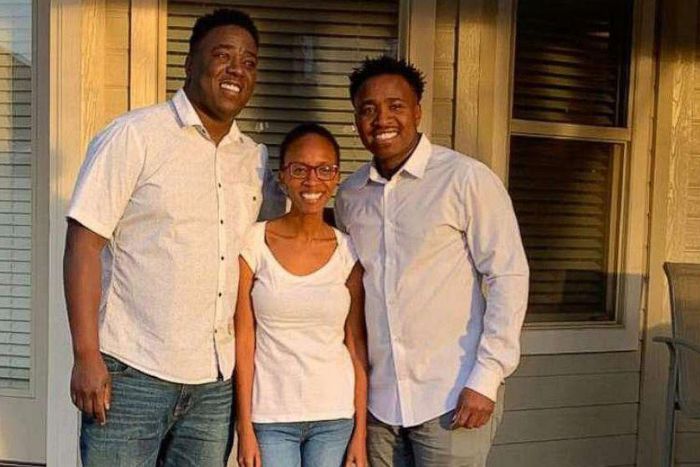 Irene Gakwa and brothers Chris and Kennedy stand in family photo