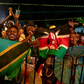 Festival-goers wave flags of Tanzania and Kenya. (Photo by BADRU KATUMBA / AFP)