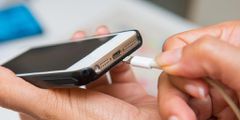 Plugging in an iPhone to charge
