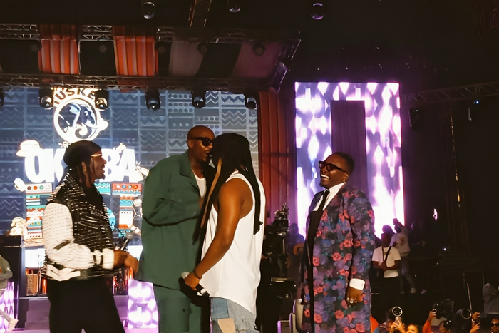 Nyashinski and Sauti Sol on stage during OkotbaFest