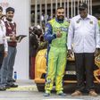 Karan Patel (R) and Tauseef Khan (L) pose for a photo with former president Uhuru Kenyattta during the Safari Rally Kenya 2022 which was held from June 23 to 26, 2022