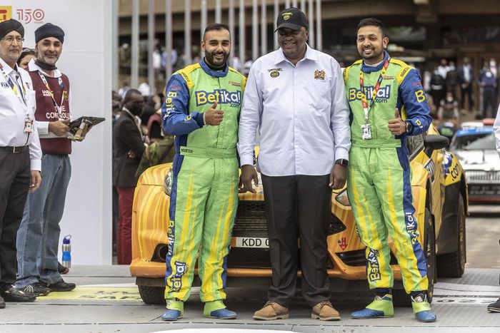 Karan Patel (R) and Tauseef Khan (L) pose for a photo with former president Uhuru Kenyattta during the Safari Rally Kenya 2022 which was held from June 23 to 26, 2022