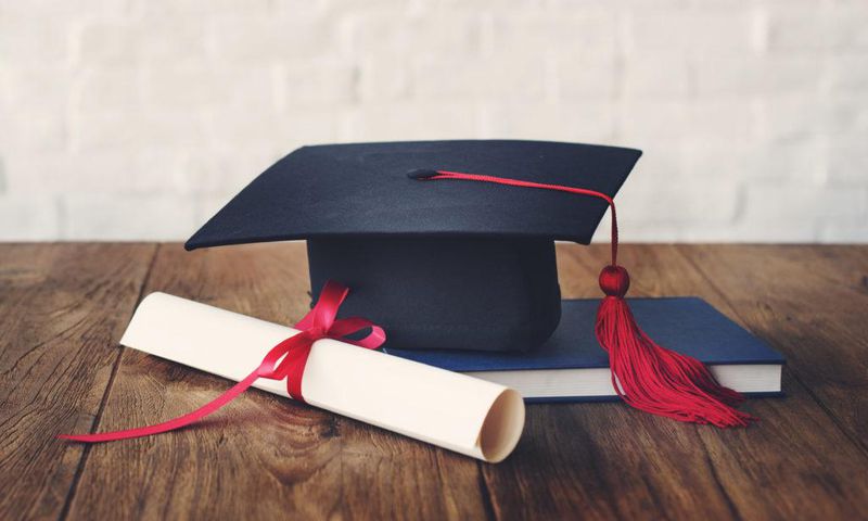 A photo illustration showing a graduation cap