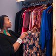 A woman arranging her wardrobe