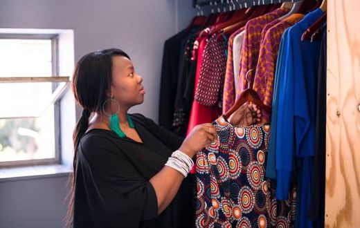 A woman arranging her wardrobe