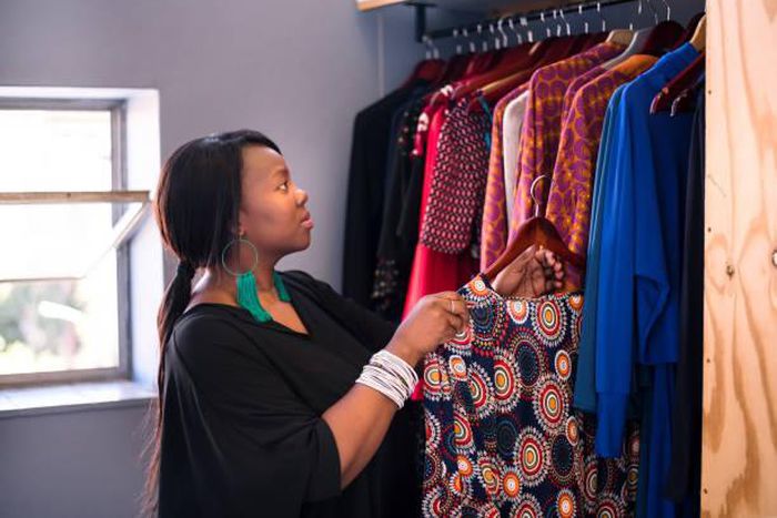 A woman arranging her wardrobe