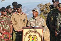 Interior CS Kithure Kindiki addressing the media while flanked by security bosses