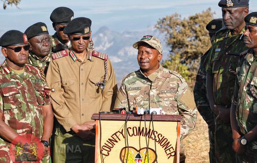Interior CS Kithure Kindiki addressing the media while flanked by security bosses