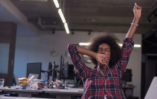 woman yawning at work tired