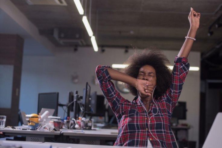 woman yawning at work tired