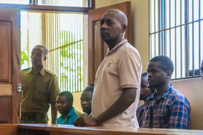 Pastor Paul Mackenzie Nthenge  accompanied by some of his followers during a court appearance in Malindi on April 17, 2023 [Photo: AP]