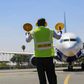 An aircraft marshal guides a plane at JKIA