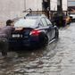 A man pushes a car through the flooded streets of Red Hook in Brooklyn on September 29, 2023.Spencer Platt/Getty Images