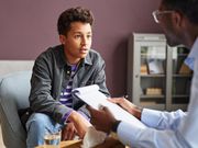 A young man during a counselling session with a professional