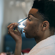 A man applying makeup