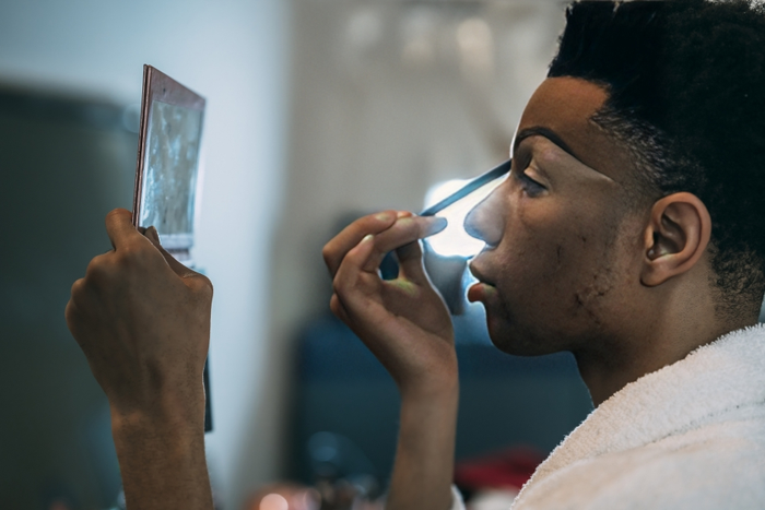 A man applying makeup