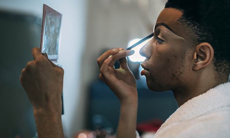 A man applying makeup
