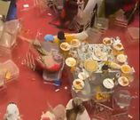 Two women stumble to the ground after a fight erupts during a wedding in Mombasa