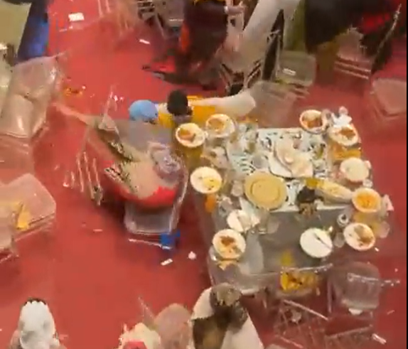 Two women stumble to the ground after a fight erupts during a wedding in Mombasa