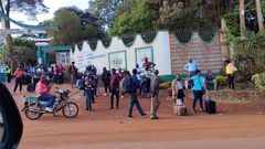 Examiners leave St Francis Girls Mangu High School after the examination centre was closed following a strike
