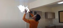 Stephen Kasolo unwrapping lights at his new apartment