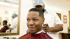 A man getting a haircut in a barbershop