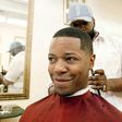 A man getting a haircut in a barbershop