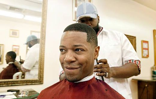 A man getting a haircut in a barbershop