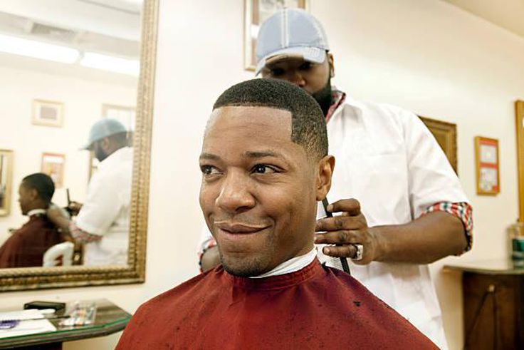 A man getting a haircut in a barbershop