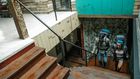 Couple of unrecognizable travelers with backpacks walking upstairs [Image credit: George Pak]