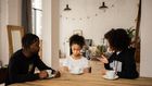 Black parents lecturing upset daughter at table [Credit: Monstera Production]