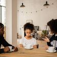 Black parents lecturing upset daughter at table [Credit: Monstera Production]