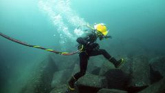 A diver repairing an undersea cable